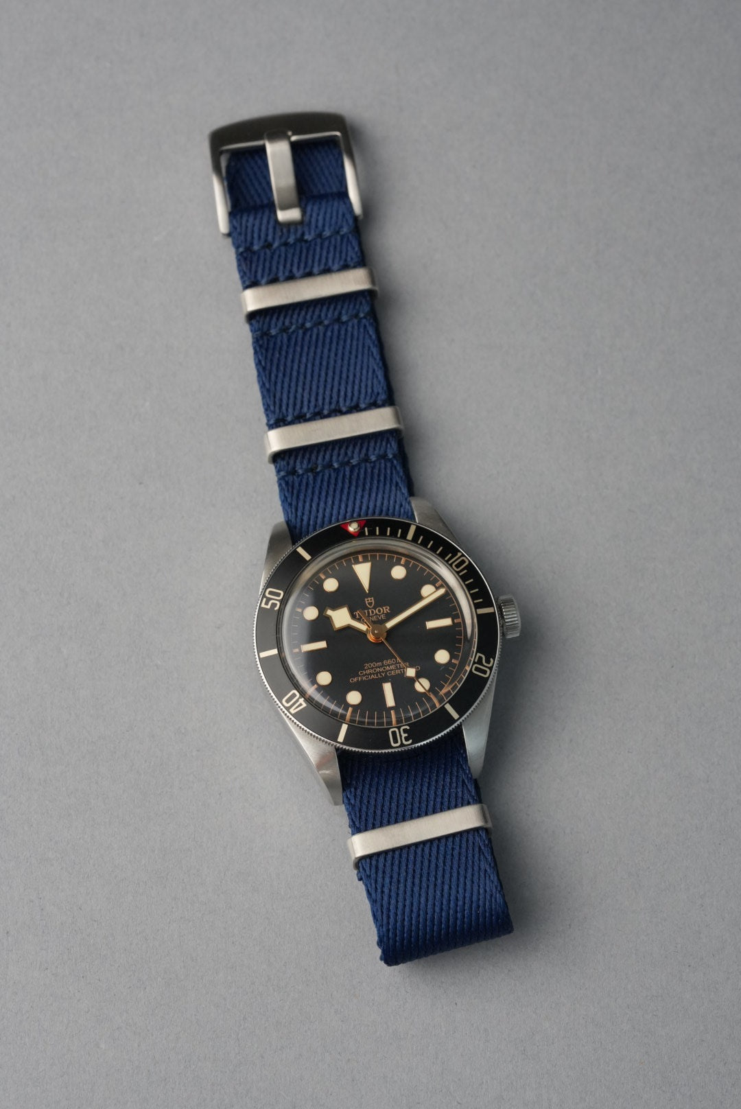 Watch with a blue strap on a gray background