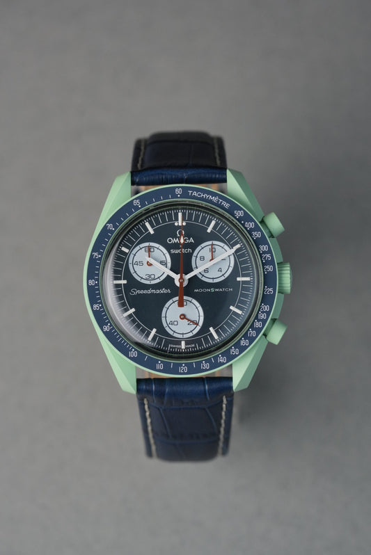 Green and blue watch on a gray background