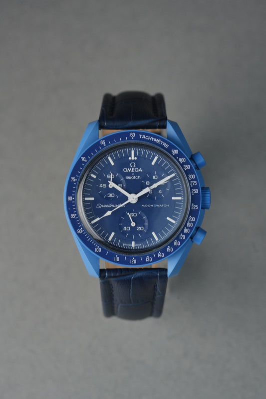 Blue watch with a detailed face on a gray background