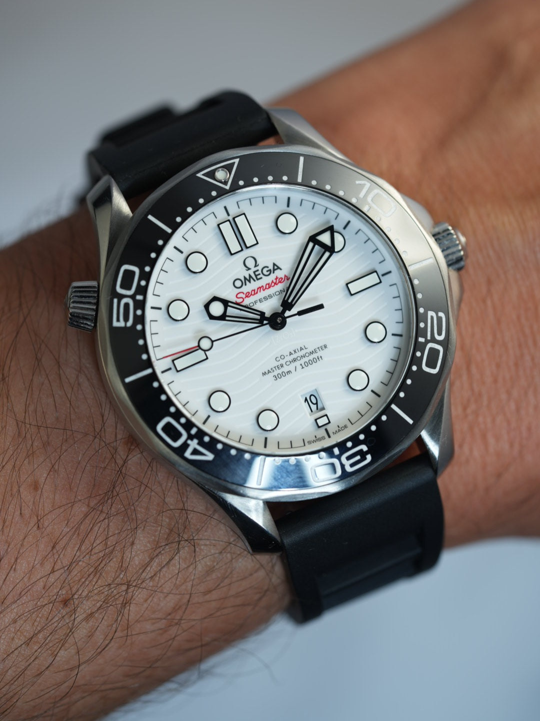 Premium black FKM rubber watch strap attached to an Omega Seamaster, showcasing a stylish and functional fit for divers and watch enthusiasts.