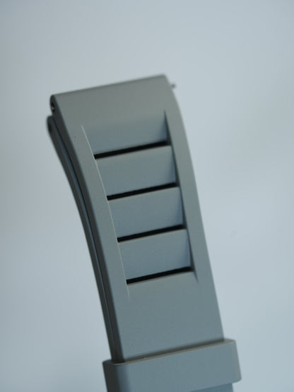 Detailed view of the grey FKM rubber strap’s vented design and engraved 20mm size marking, ideal for MoonSwatch enthusiasts