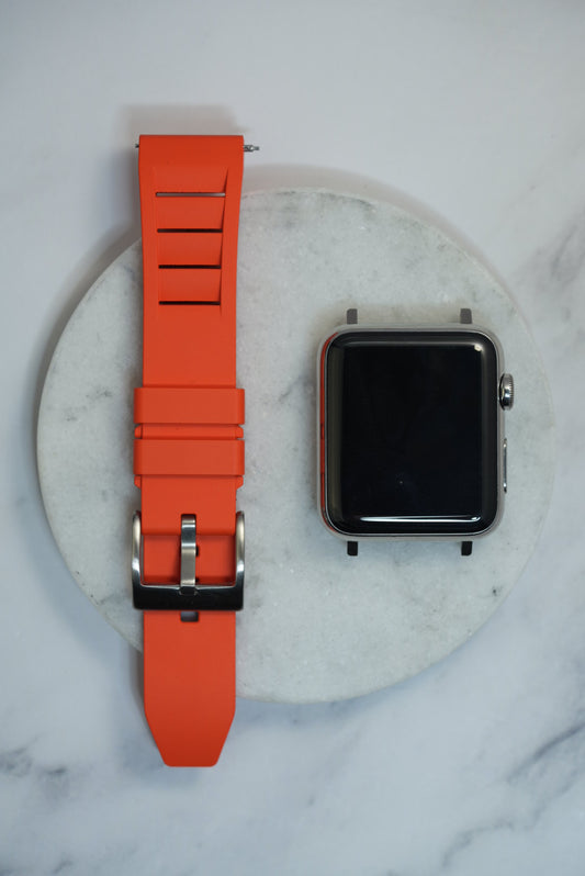 Bright orange FKM rubber watch strap with a vented design and stainless steel buckle, designed for comfort and durability. Compatible with Apple Watch and traditional timepieces
