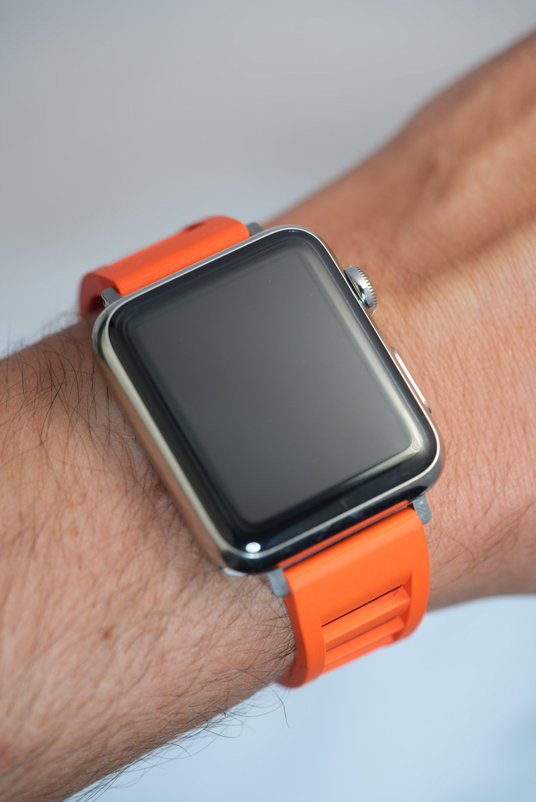 Premium vented orange FKM rubber watch strap on a wrist, offering a comfortable fit and a bold, stylish look for Apple Watch users