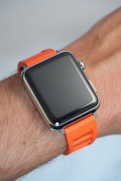 Premium vented orange FKM rubber watch strap on a wrist, offering a comfortable fit and a bold, stylish look for Apple Watch users