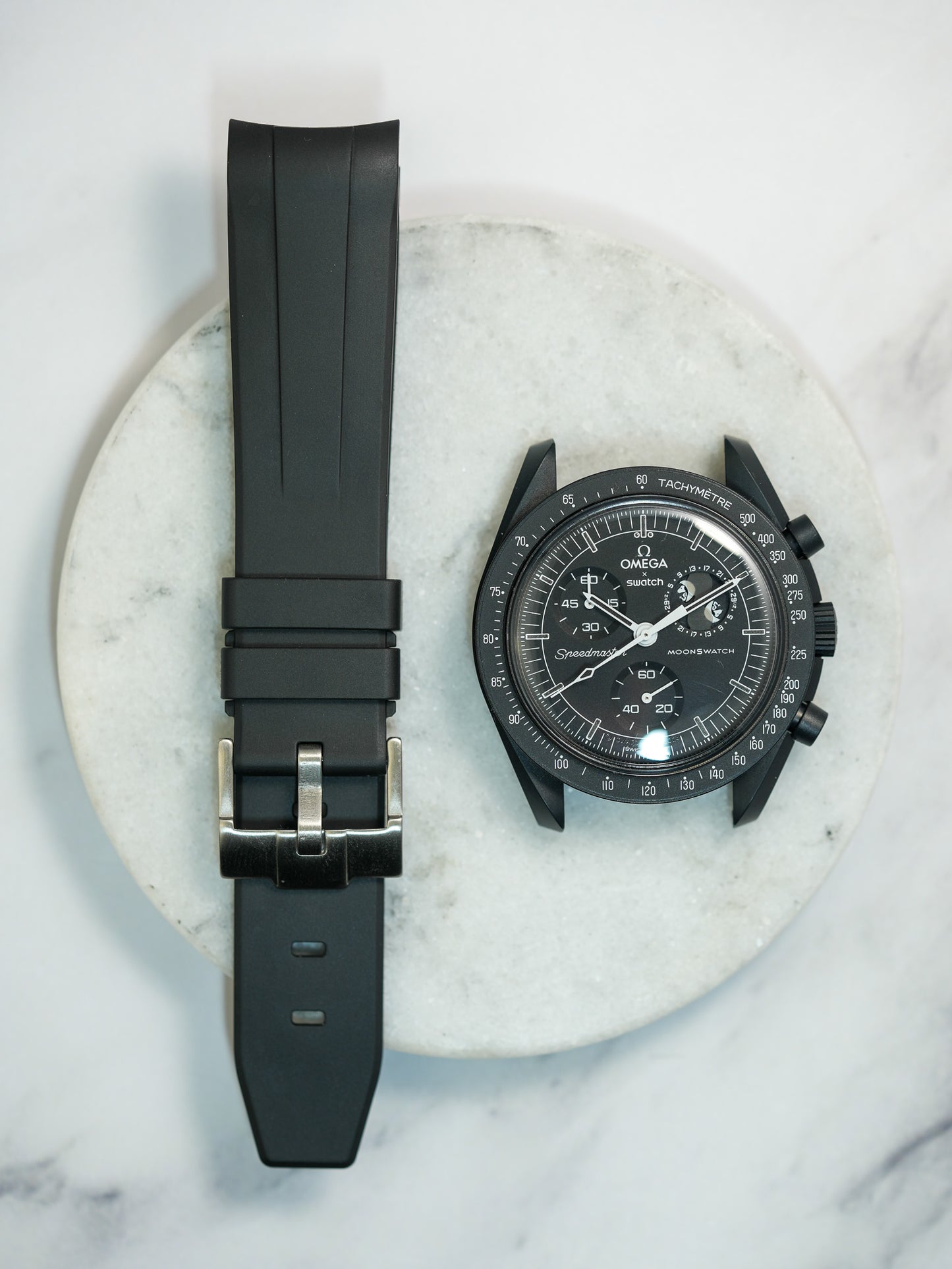 Black curved-end FKM rubber strap paired with the Swatch x Omega MoonSwatch Mission to the Moon – showcasing a secure fit and stylish upgrade for any luxury timepiece.