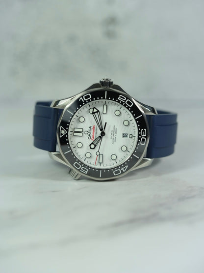 Front view of an Omega Seamaster watch with a Navy FKM rubber strap, showcasing its sleek design on a marble background.