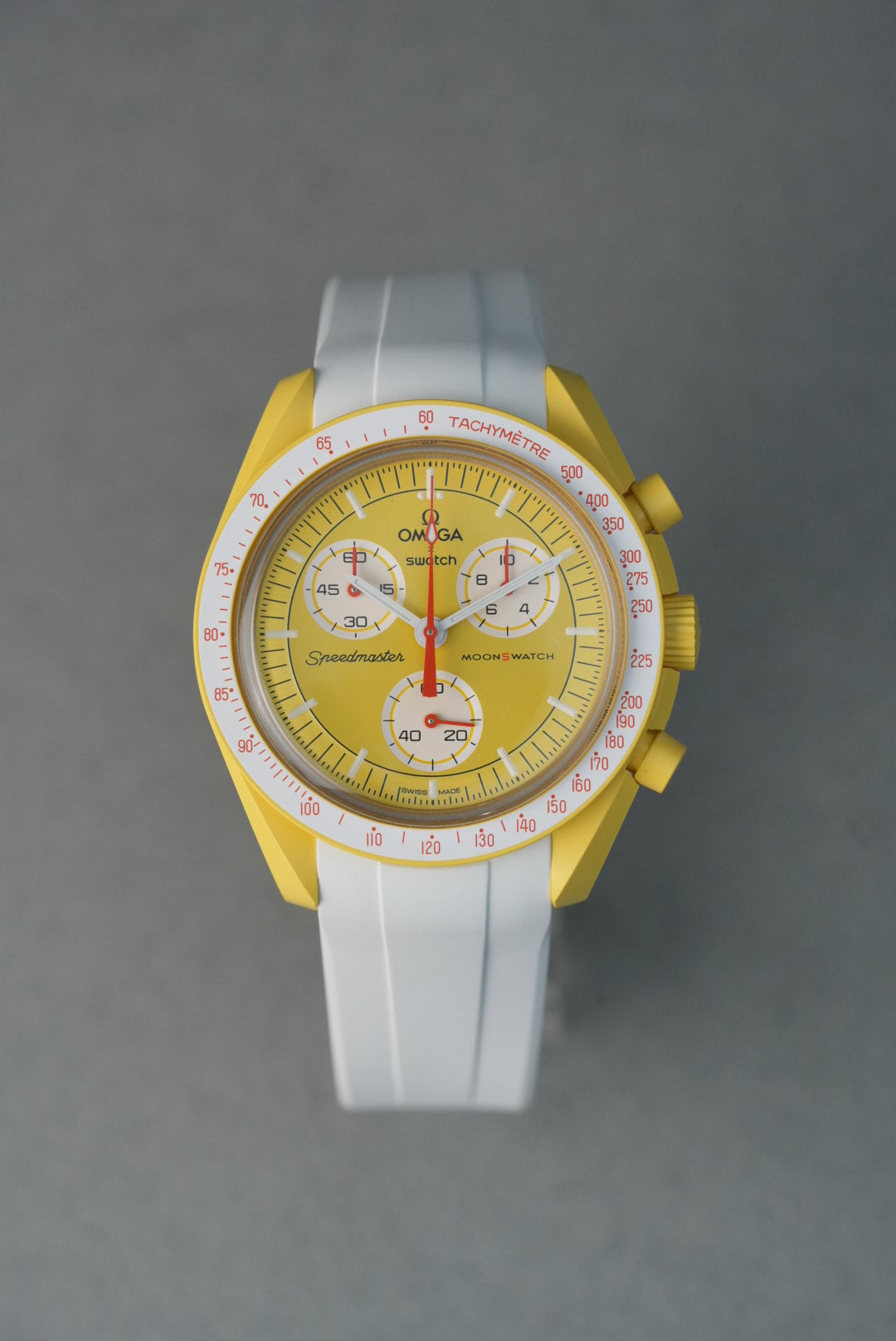 Yellow watch with white strap on a gray background