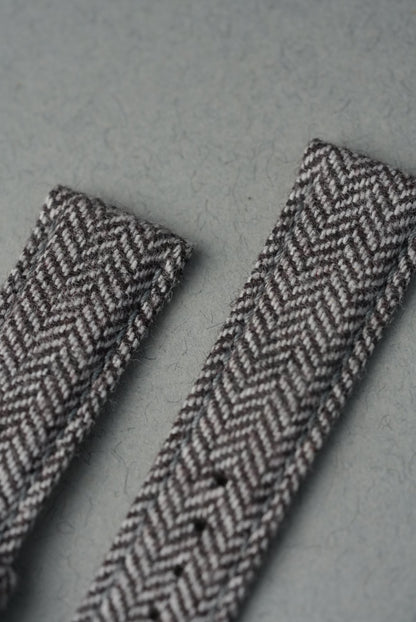Two herringbone-patterned ribbons on a gray background