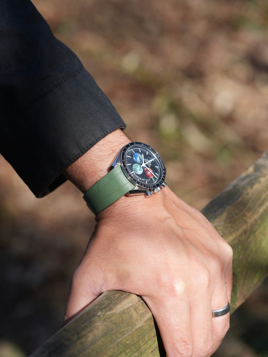 Wrist shot of green FKM curved-end rubber strap fitted to a MoonSwatch case – stylish, comfortable, and ideal for MoonSwatch, Rolex, and Tudor watch collectors.