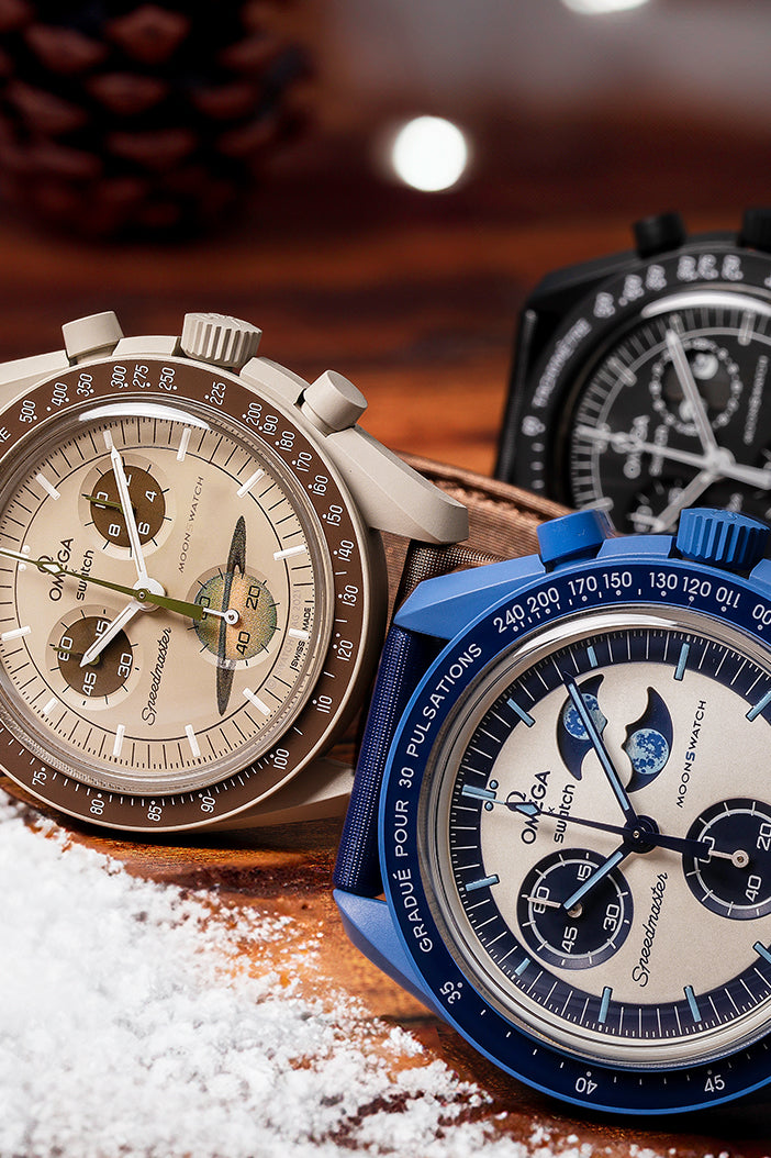 Three watches on a wooden surface with a blurred background