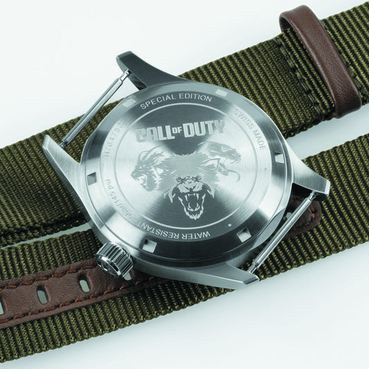 Watch with 'Call of Duty' design on the back, featuring a brown strap and silver case.