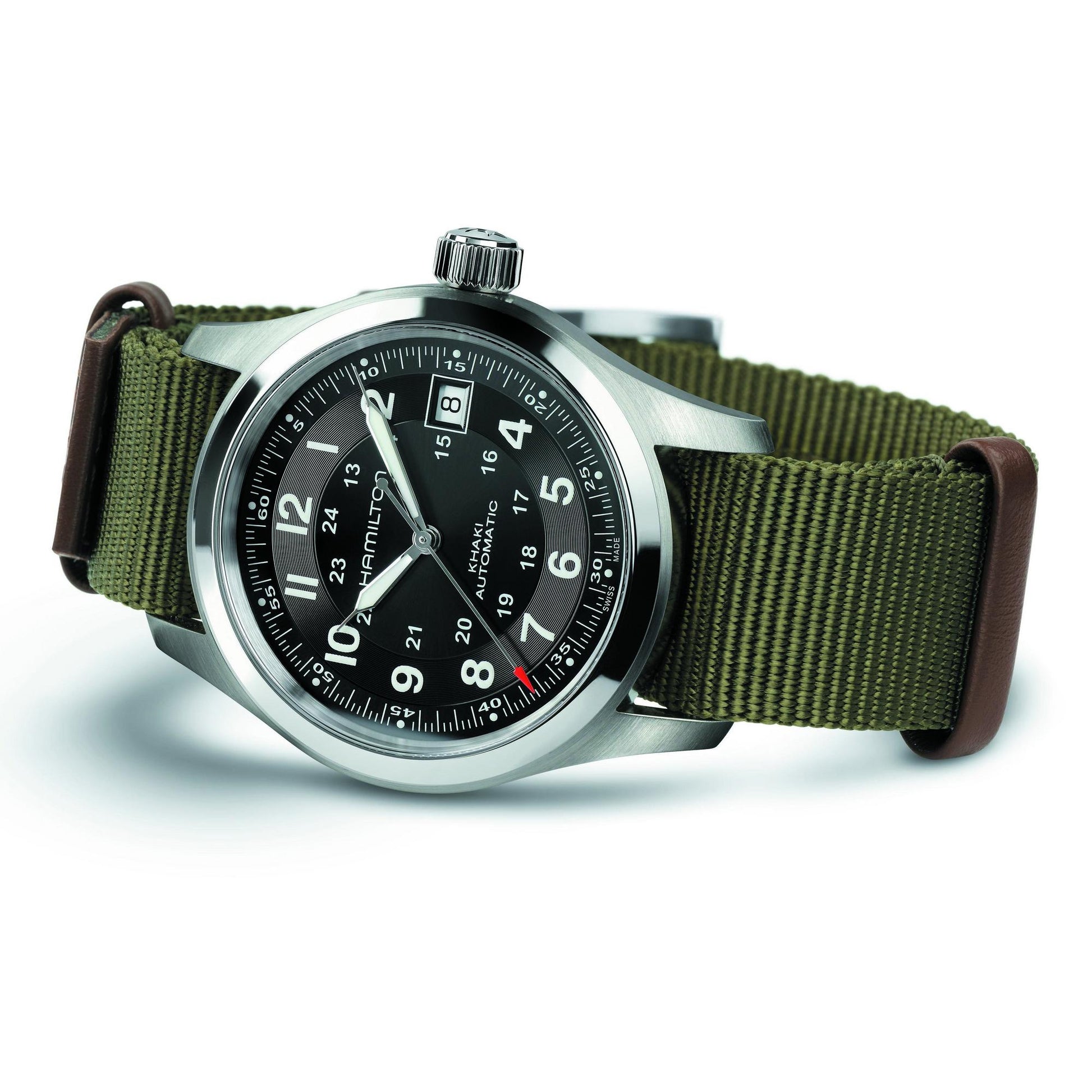 Watch with green strap and black dial on a white background
