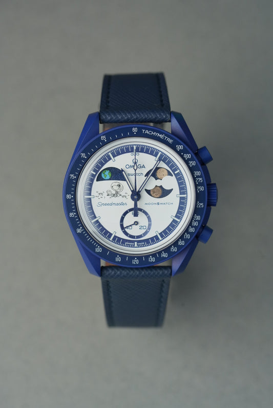 Blue wristwatch with detailed face on a gray background