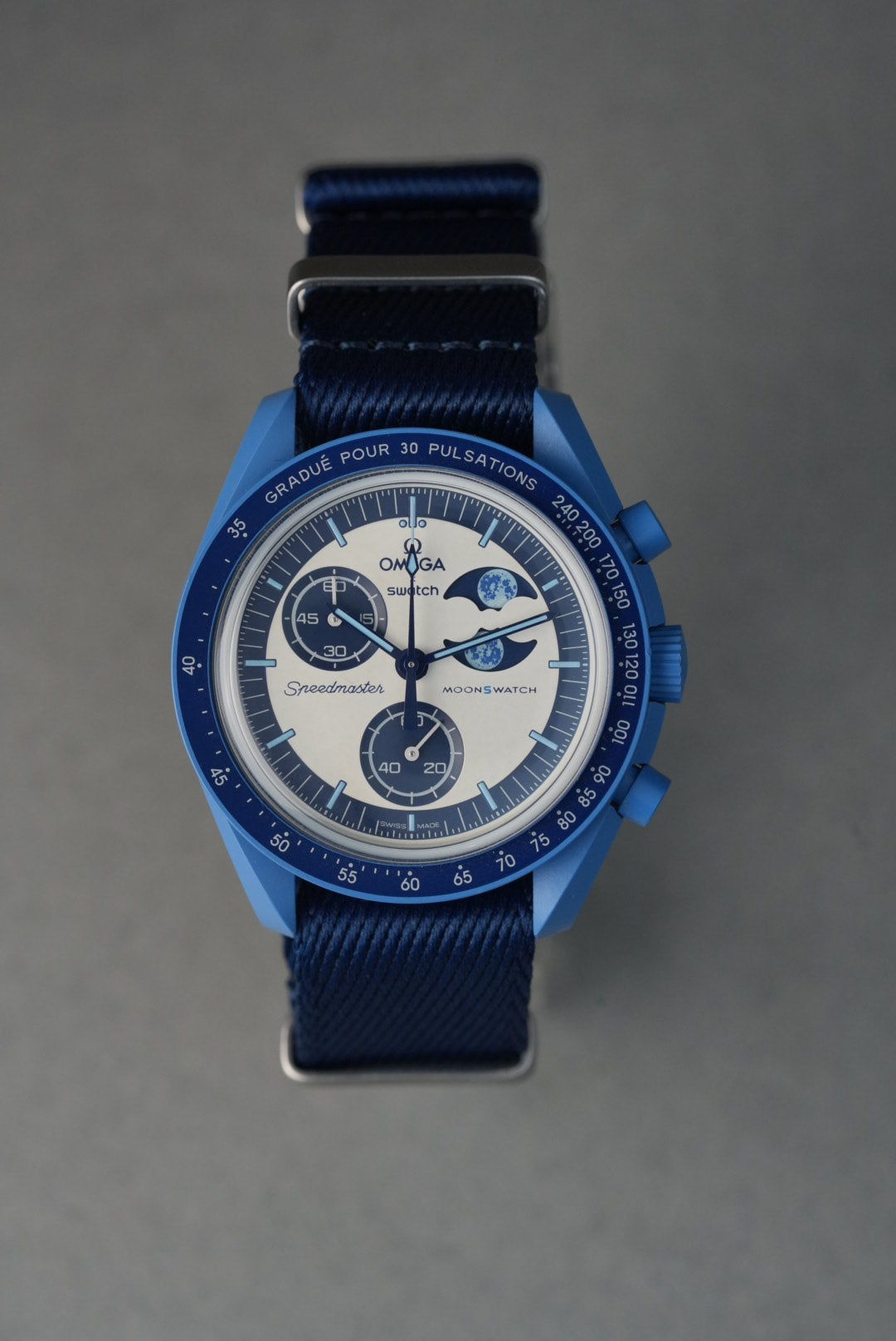 Blue watch with a detailed face on a gray background