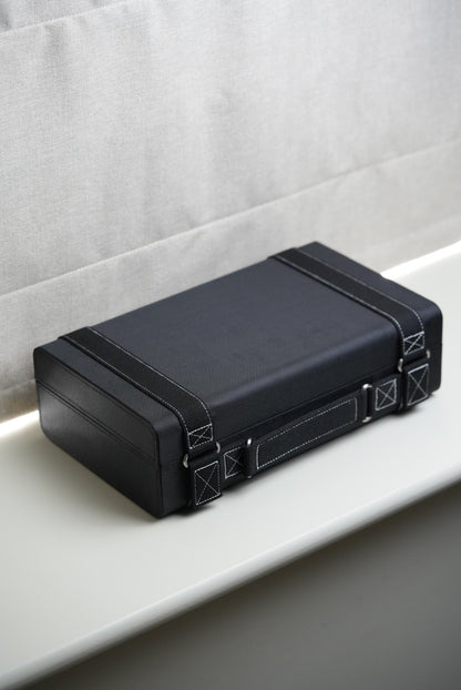 Black rectangular case with textured surface on a light gray background