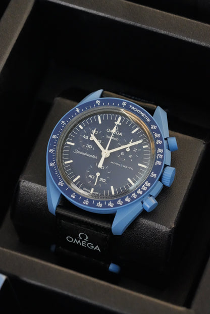 Omega watch with blue bezel and face in a black box