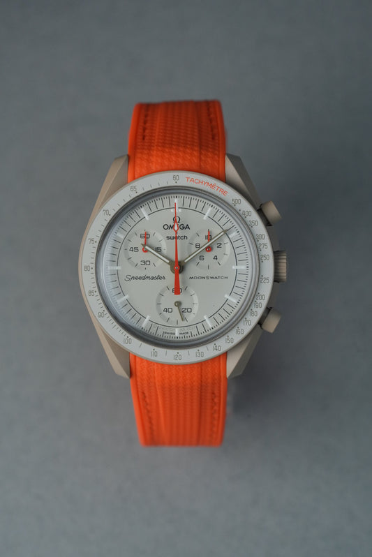Watch with an orange strap on a gray background