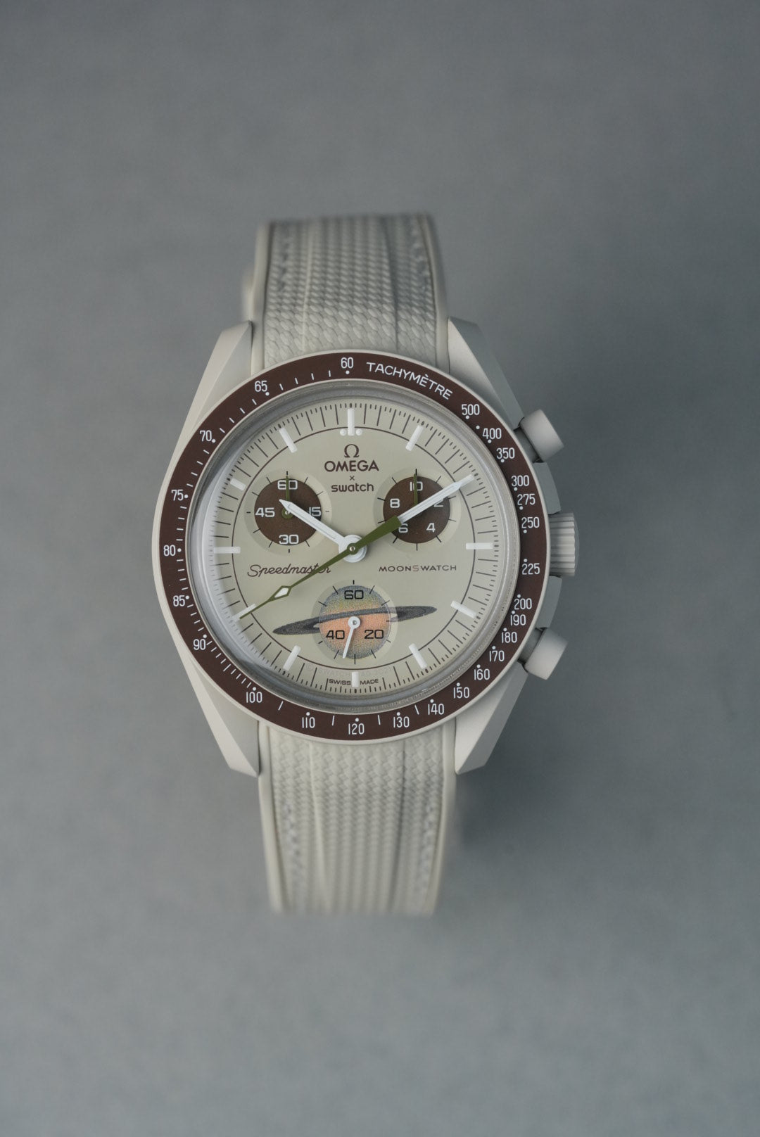  Beige rubber woven MoonSwatch strap with matching stitching and curved fit for a subtle, neutral aesthetic.