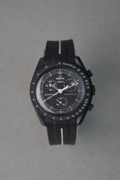 Black wristwatch with detailed face on a gray background