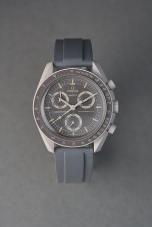Silver watch with a black strap on a gray background