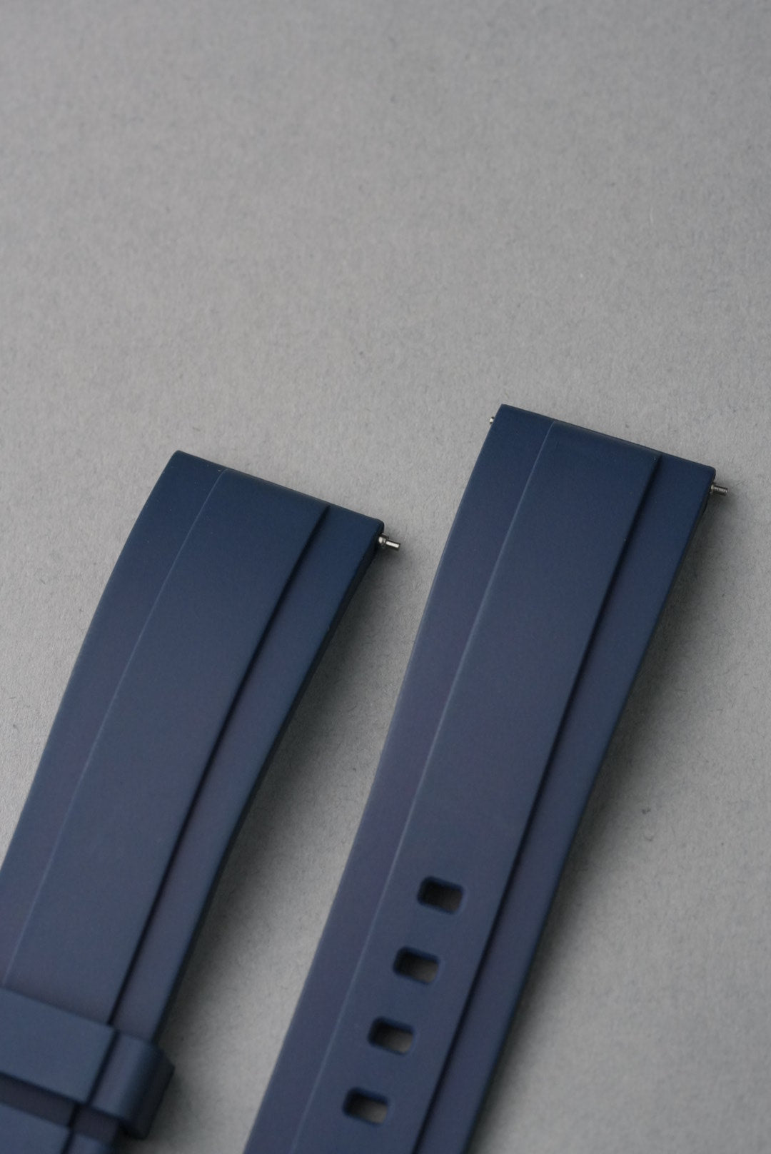 Blue watch strap on a light gray background