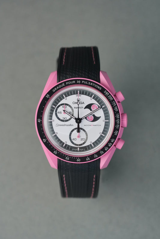 Pink and black watch with Omega branding on a gray background