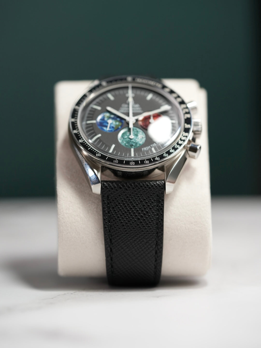 Omega Speedmaster with Black Saffiano Leather Strap on display pillow