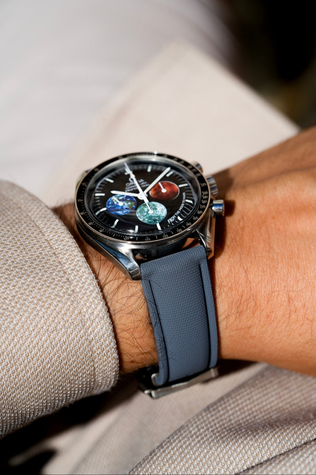 Watch with a blue strap on a wrist, close-up shot