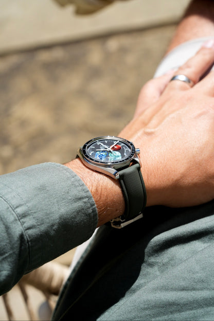 Close-up of a wrist wearing a smartwatch with a blurred background