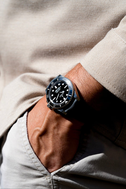 Person wearing a watch with a neutral background