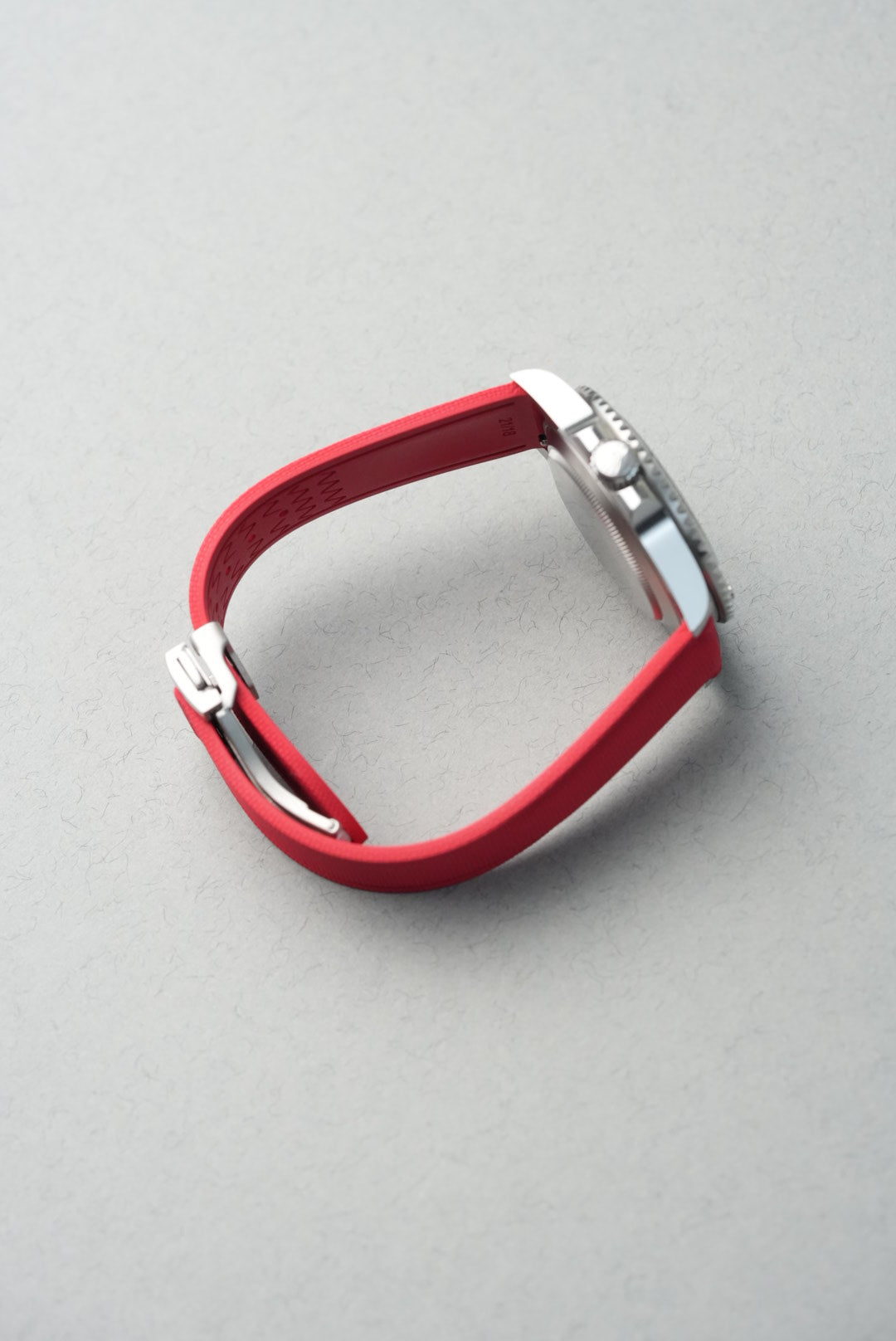 Red equestrian bit on a gray background