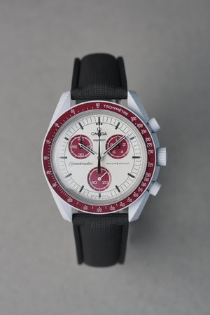Omega watch with black strap and red accents on a gray background
