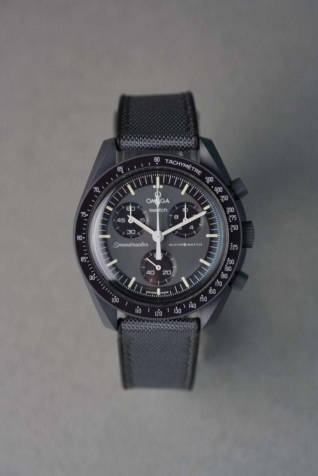 Black watch with detailed face on a gray background