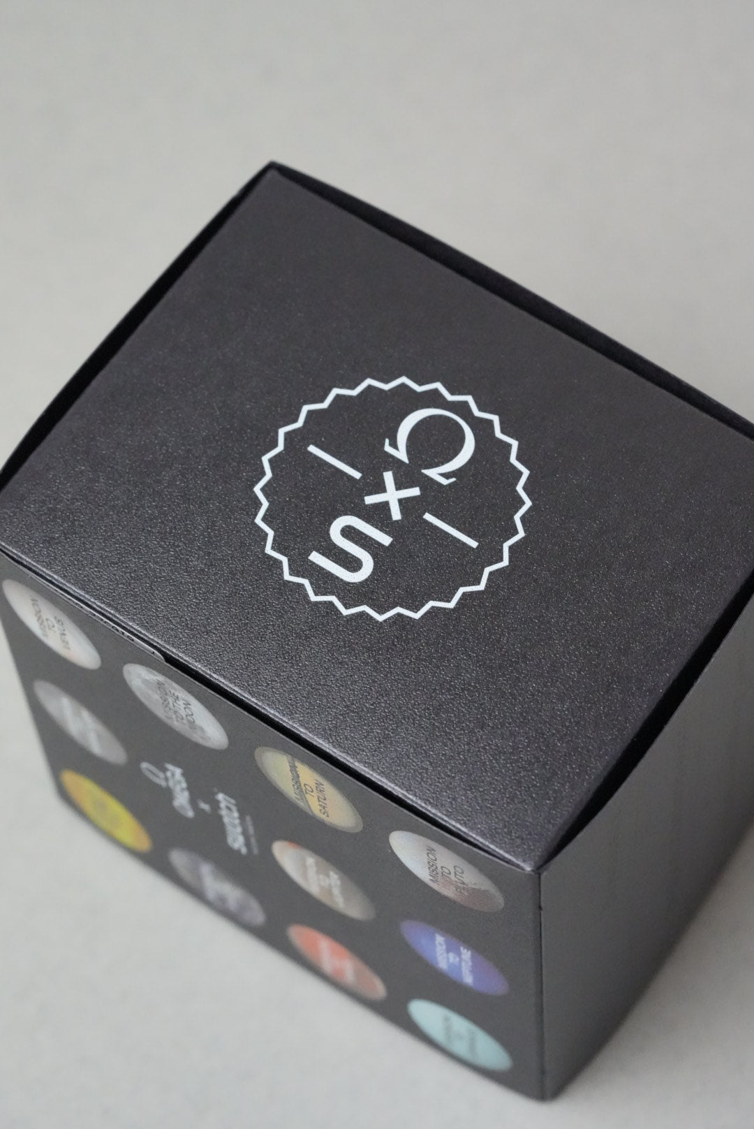A Black Swatch x OMEGA MoonSwatch Box laid on its side