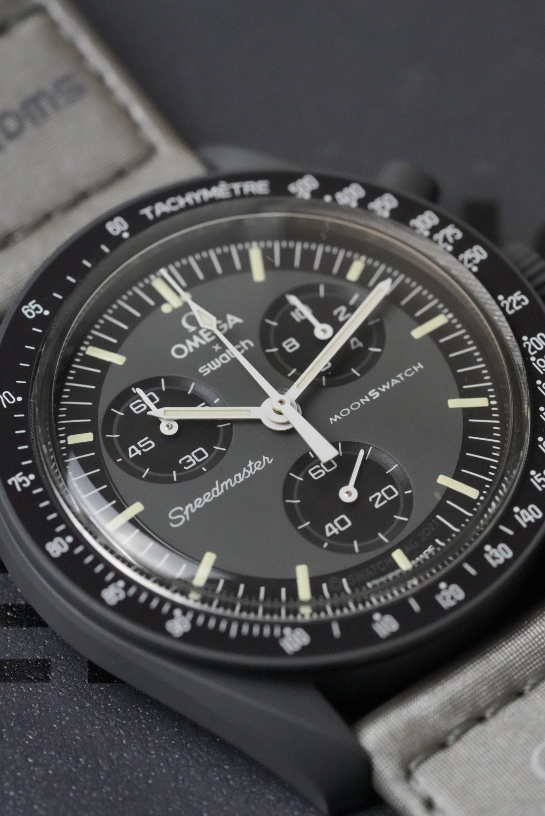 Close-up of a detailed watch face with visible Omega branding