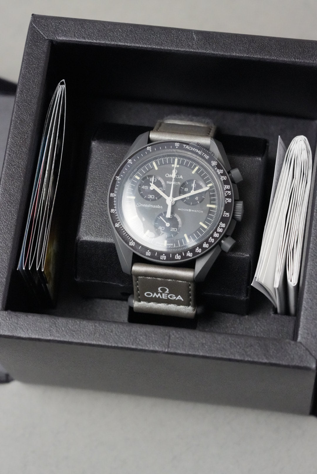 Omega watch in a black box with a white cloth