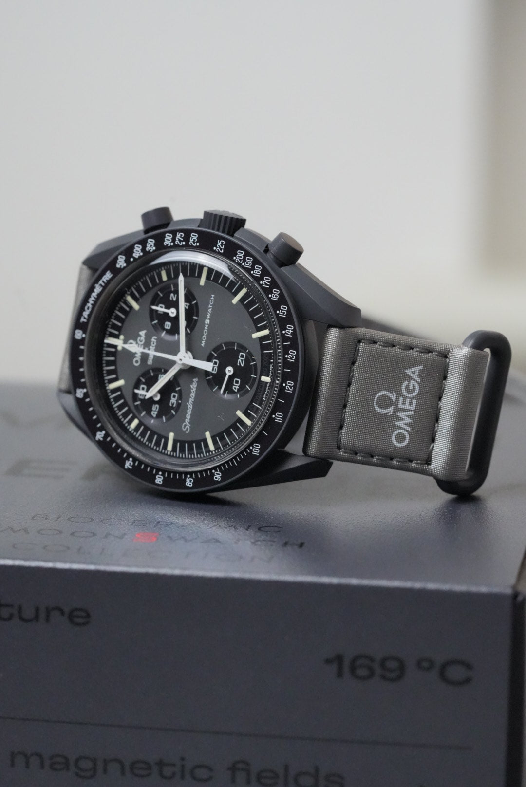 Omega watch with black strap on a white background