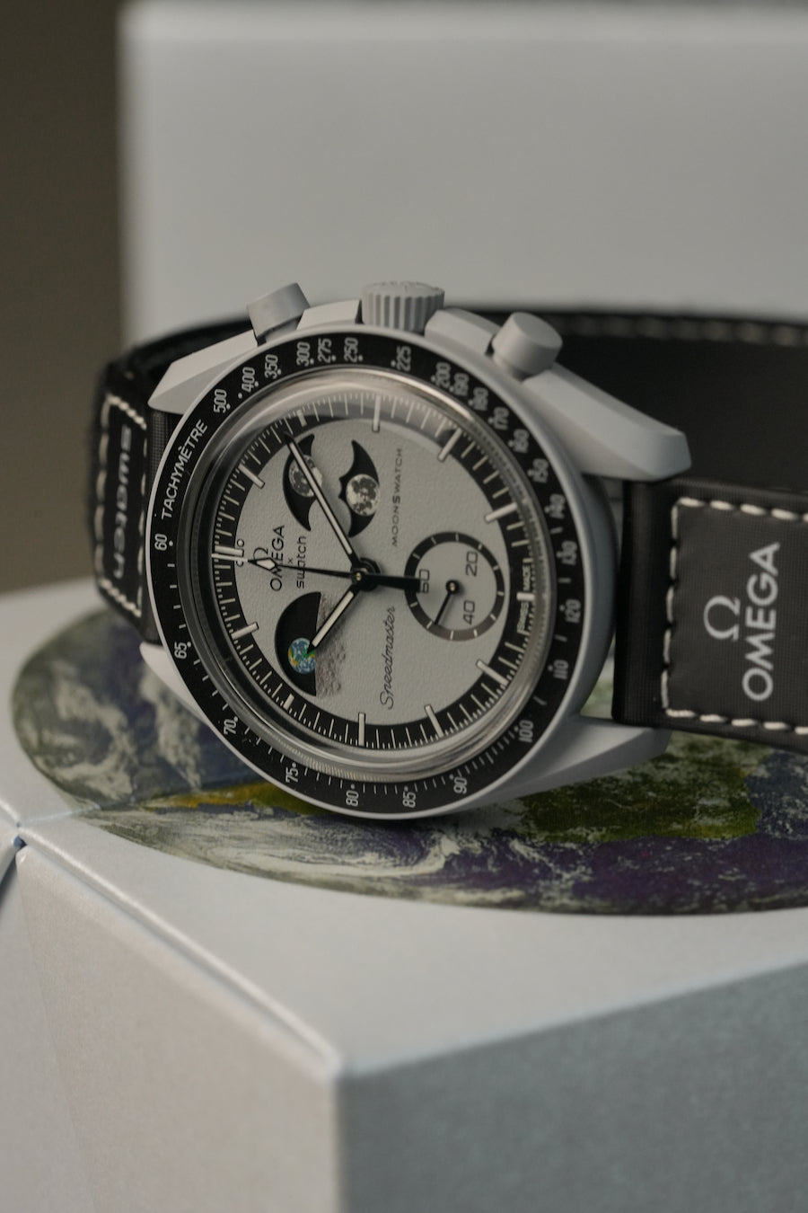 Omega watch on a decorative surface with a blurred background