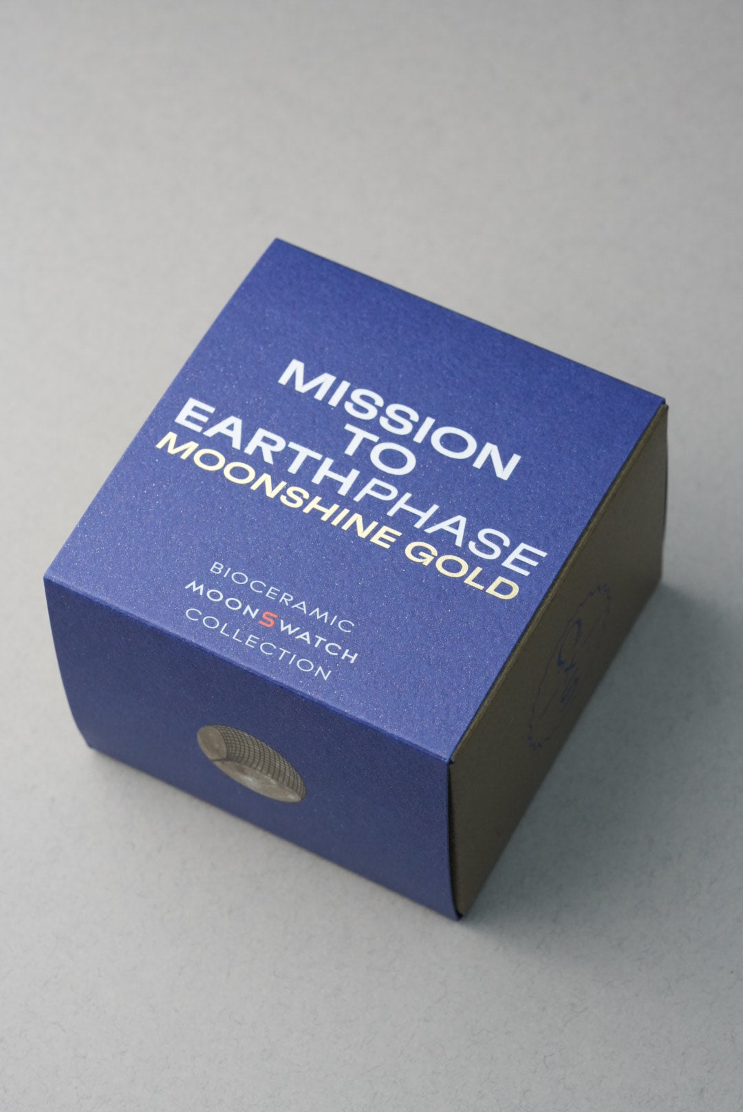 Swatch x Omega MoonSwatch Collection: Mission to EarthPhase - Moonshine Gold SO33N701L Box