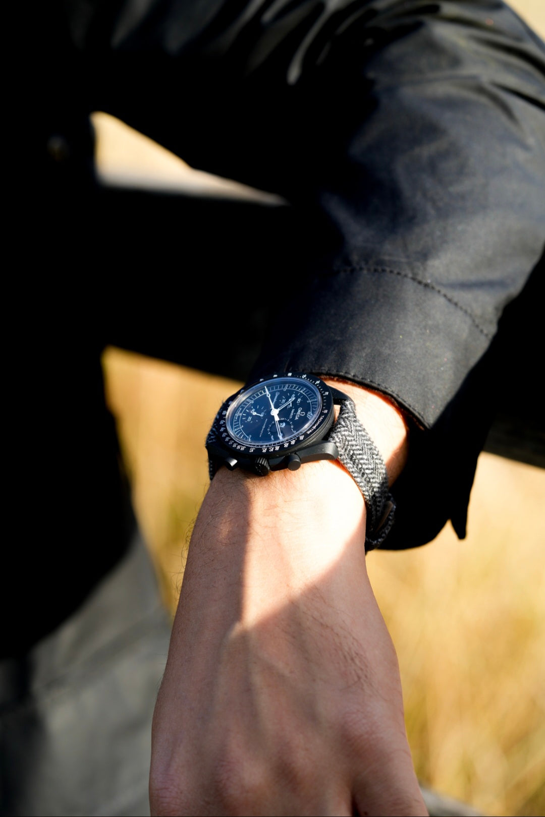 Person wearing a black watch with a blurred background