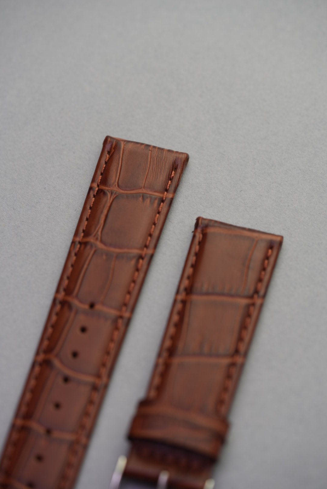 Close-up of almond light brown alligator-style calfskin leather strap – premium texture for replacement watch straps.