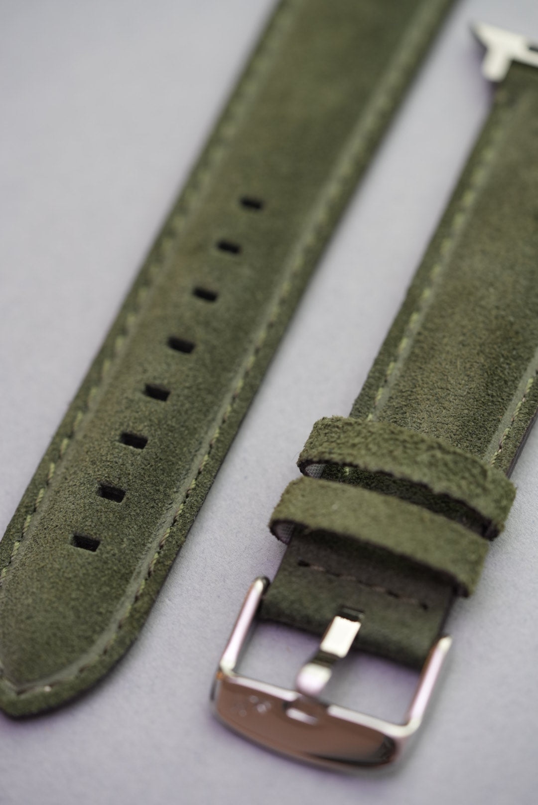 Close-up of green suede strap showing buckle and keepers – fits all Apple Watch models