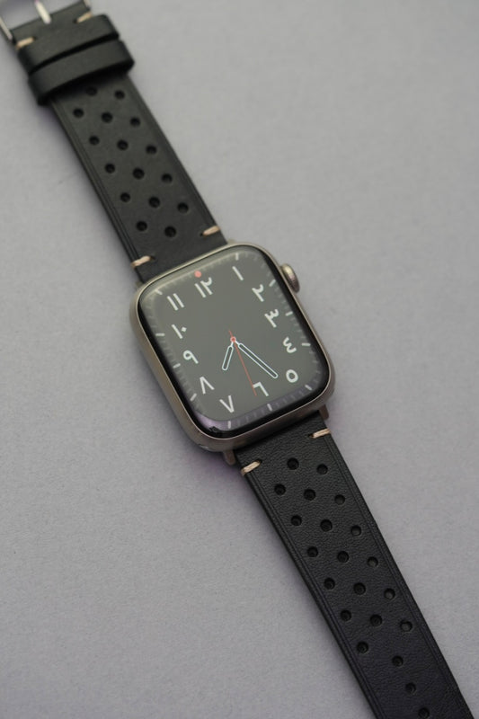 Black perforated leather strap fitted to Apple Watch face for strap replacement