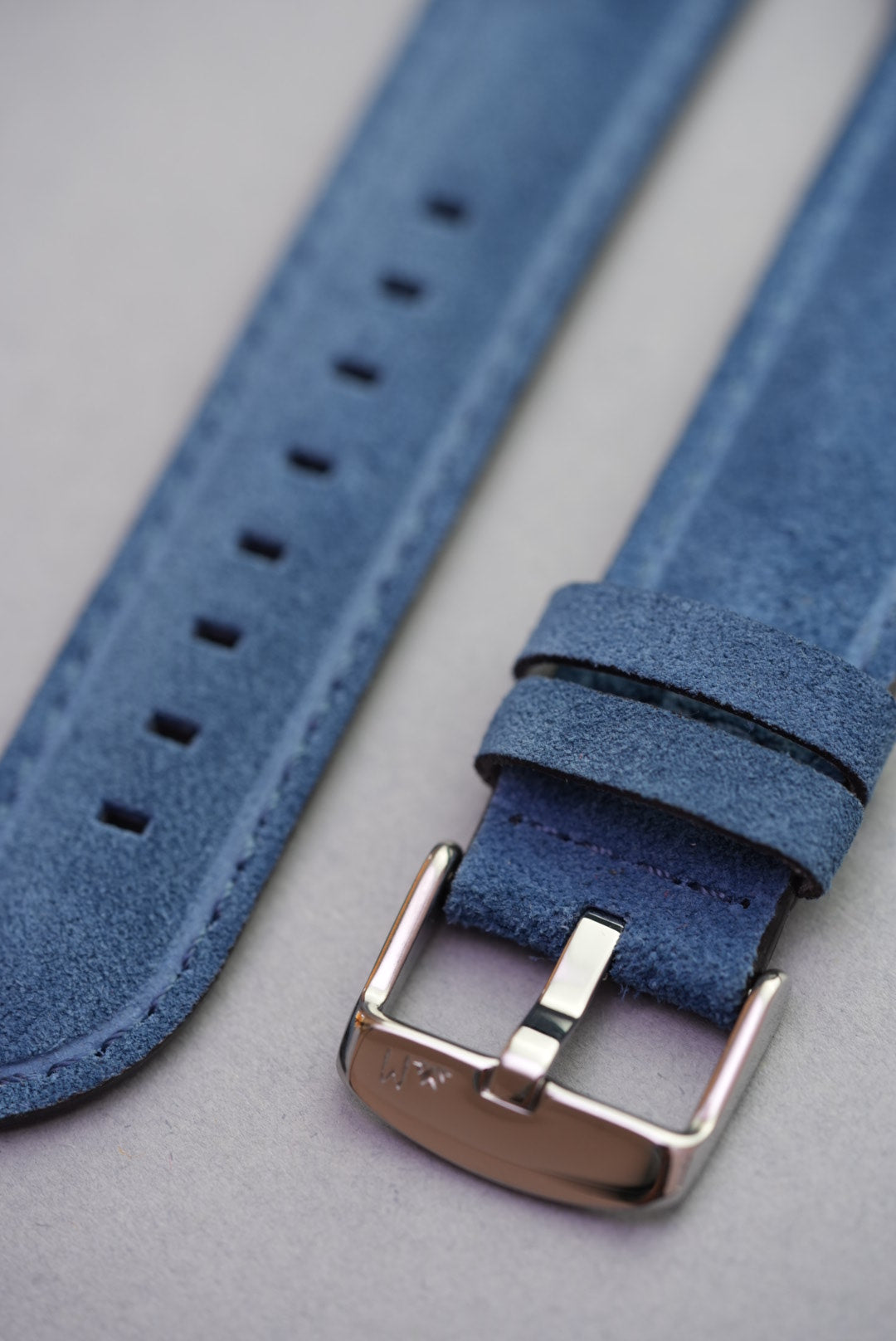 Close-up of buckle, stitching, and suede texture on blue leather Apple Watch strap – fits all Apple Watch series