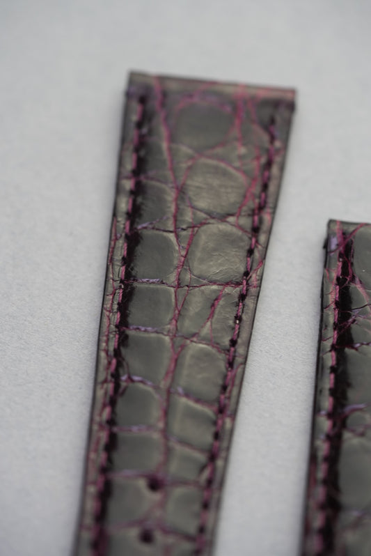 Detailed look at Bordeaux crocodile grain and contrast stitching, showcasing the natural scale variation and shine.