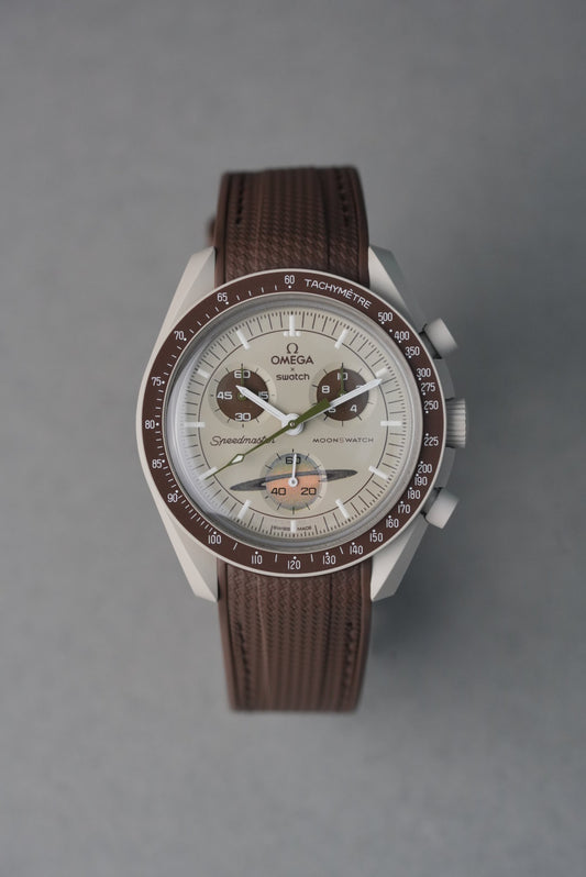 Watch with a brown strap and detailed face on a gray background