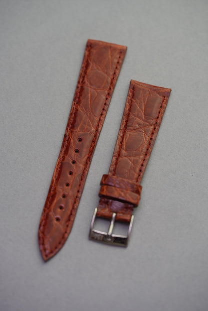 Full view of the caramel crocodile strap for Cartier, with a semi-gloss finish, natural scale texture, and polished buckle.
