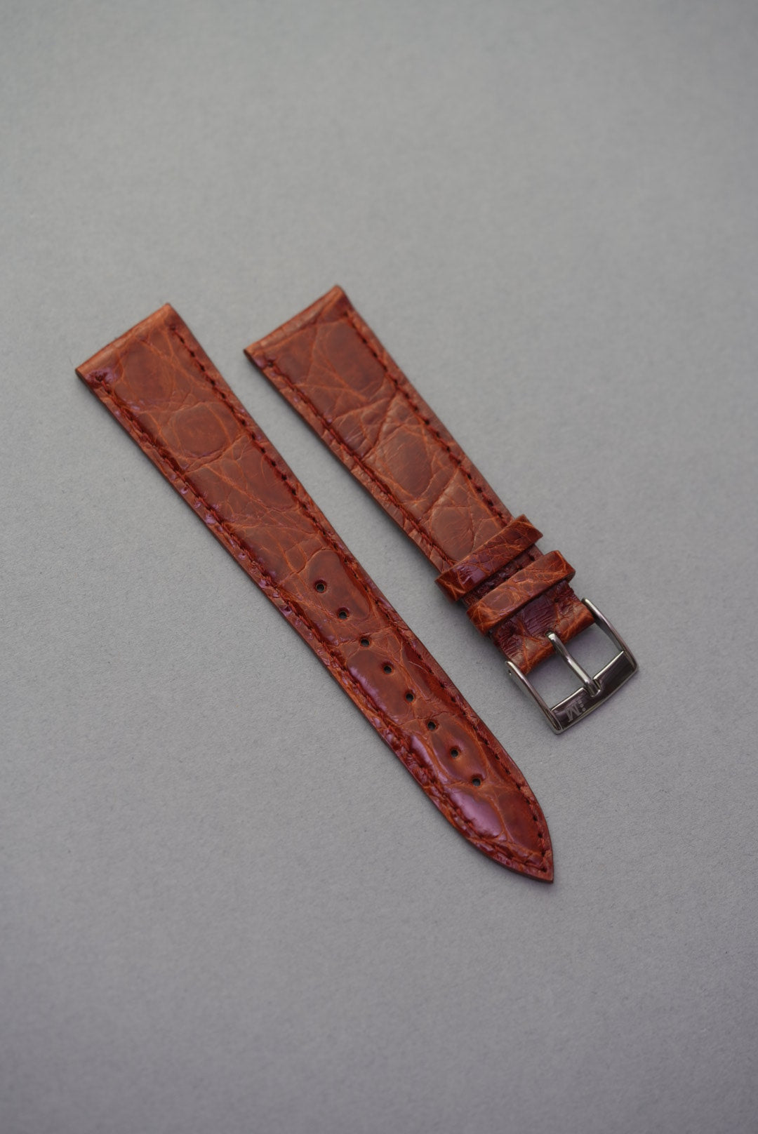 Caramel-toned crocodile leather strap for Cartier, showcasing a rich amber-brown hue with soft gloss and organic texture.