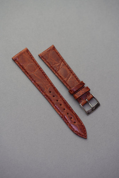 Caramel-toned crocodile leather strap for Cartier, showcasing a rich amber-brown hue with soft gloss and organic texture.