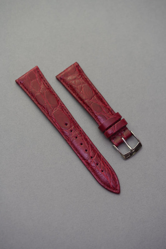Ruby red genuine crocodile leather watch strap for Cartier watches, with a high-gloss finish and natural scale texture.